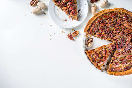 Homemade autumn pecan pie on white background, Traditional fall and winter, thanksgiving american...