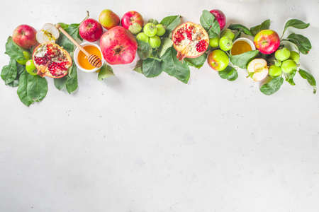 Rosh hashanah, jewish New Year holiday concept, banner. With traditional symbols, apples, pomegranate, honey. Rosh hashanah greeting card background.の写真素材