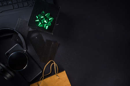 Christmas Clearance and Sale Concept. Black Friday, Green Monday (Cyber Monday) Sale. With Discount Price Tags, Black gadgets and accessories, Shopping Bag. Flat lay top view, black matte backgroundの写真素材