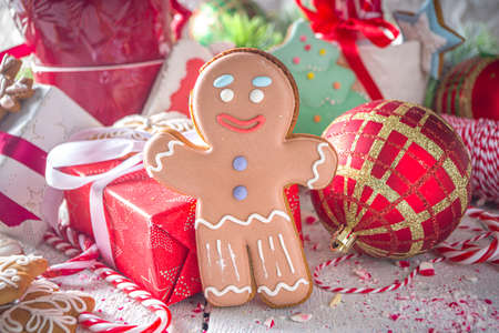 Christmas gingerbread cookies, with festive mugs for hot chocolate, Christmas decor and baubles,...