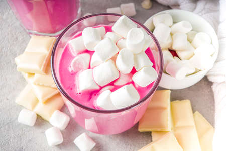 Pink beetroot latte, beets hot chocolate with marshmallow, modern sweet organic vegan drink