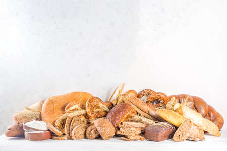 Assortment of various delicious freshly baked bread, on white background top view copy spaceの写真素材