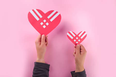 Giving Tuesday background with red hearts, Global International Charity Aid Day, Various helping traditional on November Tuesday giving day after Black Friday shopping concept flatlay top viewの写真素材