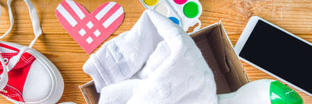 Donation Box with various give goods for Giving Tuesday, with red heart logo. Charity. Collect unwanted waste goods, pass it poor needy people concept. Participating in international donation drive.の写真素材