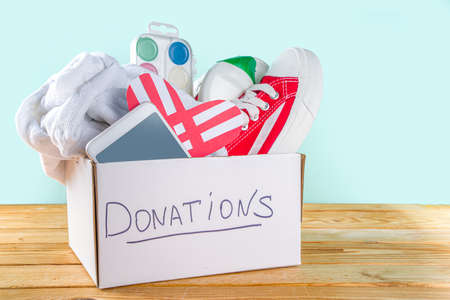 Donation Box with various give goods for Giving Tuesday, with red heart logo. Charity. Collect...