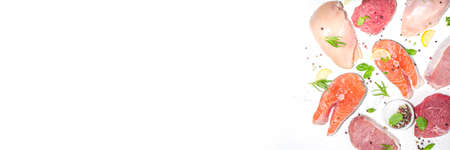 Various natural food, high animal protein sources - pork, beef meat steaks, chicken breast fillet, eggs, salmon fish on white table background top view copy spaceの写真素材