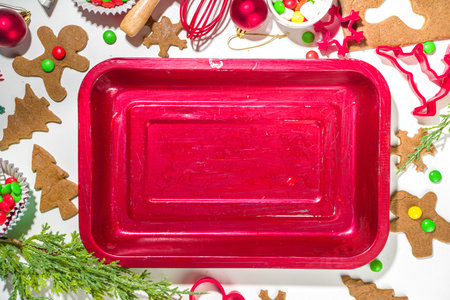 Christmas, New Year cooking background. Baking ingredients and utensils - gingerbread dough, cookie cutters, rolling pin. Making festive Christmas sweet cookies bright festive red white conceptの写真素材