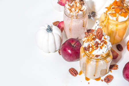 Apple pumpkin and pecan pie smoothie drinks. Traditional autumn baking cake flavor cocktails set, on white background copy spaceの写真素材