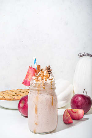 Apple pie smoothie. Crazy shake cocktail with traditional autumn apple pecan flavor, white background copy spaceの写真素材