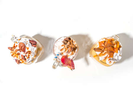 Apple pumpkin and pecan pie smoothie drinks. Traditional autumn baking cake flavor cocktails set, on white background copy spaceの写真素材