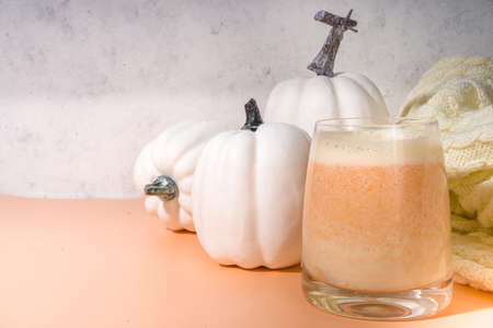 Autumn warm drinks. Homemade spicy dairy pumpkin creamer made from cream or milk and pumpkin puree with spices. Liquor, ingredient for pumpkin latteの写真素材