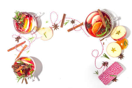 Homemade mulled wine cocktail. Various glass mugs with classic winter hot spicy mulled wine, with ingredients on white background flatlay top view copy spaceの写真素材