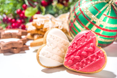 Christmas greeting card background with Xmas tree balls, decorations, red gift box with festive ribbon, fir tree, gingerbread and cookies, with background with bokeh effect, copy spaceの写真素材