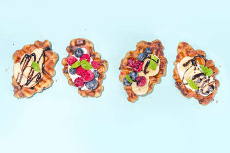 Modern dessert croffle - mixture of croissants and waffles, puff baking waffle iron pan, with berry, fruit cocolate toppingの写真素材