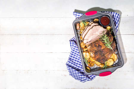 Thanksgiving dinner table with new traditional thanksgiving food - chicken, mashed sweet potatoes, green beans, pecan pie, baked ham pork, macaroni and cheese, stuffing, modern hard sunny light flatlayの写真素材