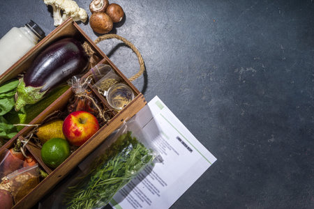 Meal Kit Delivery Concept. Set various healthy dishes food ingredients meat, vegetables, fruit, spices with recipes for cooking. Online ordering chef foods ingredients, grocery deliveryの写真素材