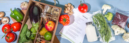Meal Kit Delivery Concept. Set various healthy dishes food ingredients meat, vegetables, fruit, spices with recipes for cooking. Online ordering chef foods ingredients, grocery deliveryの写真素材