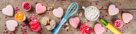 Valentine day cooking baking background. Utensils and ingredient for sweet Valentine cakes and heart shaped cookies, wooden background copy spaceの写真素材