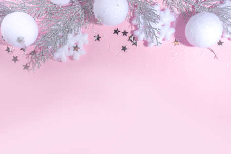 Fluffy Christmas concept. Festive Christmas background with fluffy decoration stuff, xmas ball, gift boxes, with artificial snow and shiny stars on pink color background copy spaceの写真素材