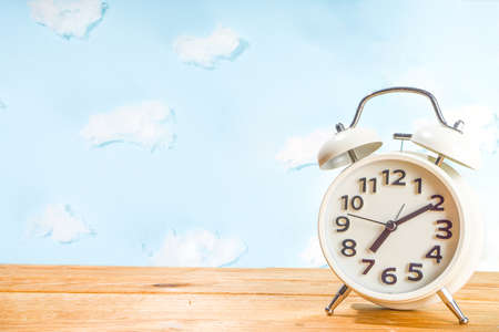 Circadian rhythms with white alarm clock, night and day backgrounds flatlay copy spaceの写真素材