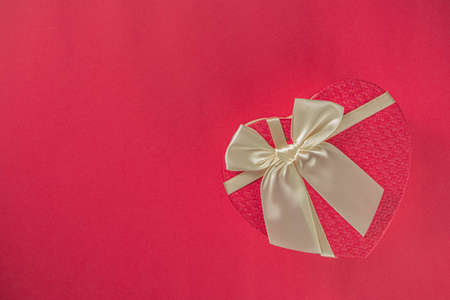 Valentine day Greeting background, heart shaped gift box with red ribbon bow, copy space for your...