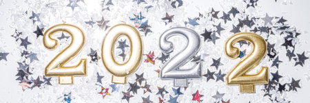 2022 new year greeting card background, festive banner with 2022 holiday candles, silver star decor,...