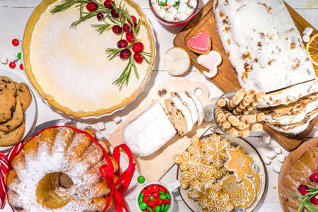 Assortment Christmas homemade baking sweet. Set of various traditional Christmas pastry cheesecake, fruitcake, stollen, gingerbread, biscuits, panettone. Bakery menu, Xmas banquet invitationの写真素材