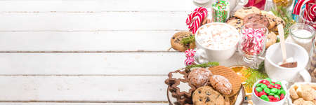 Christmas hot chocolate party bar, winter cocoa buffet with a lot of hot chocolate mugs, various topping, sprinkles, sweet appetizers