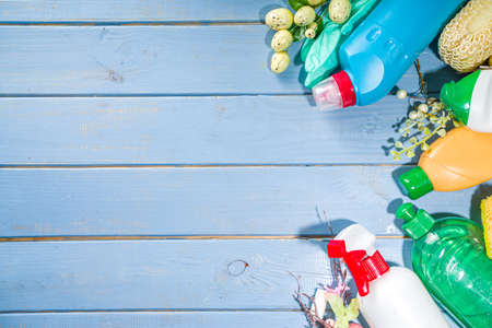 Spring cleaning concept. Sun lighted bright blue background with cleaning items, bottles, equipment, supplies. Housecleaning, hygiene, chores conceptの写真素材