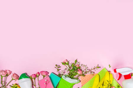 Creative bright spring cleaning concept. Tools, bottles, accessories for cleaning house with spring...