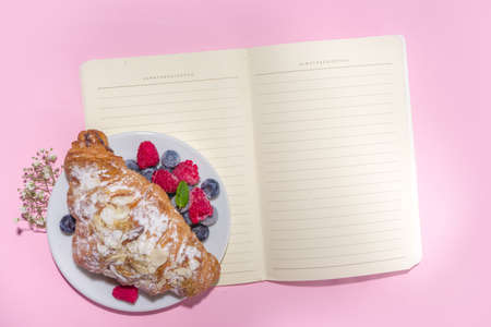 Croissant with coffee and Valentines gift and coffee latte mug on pink background copy space. Valentine day, Mother day sweet tasty breakfast idea. Good morning and nice spring, summer day conceptの写真素材