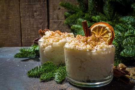 Risgrynsgrot, scandinavian-style Christmas rice porridge with cinnamon and spices, with Christmas tree branches decorの写真素材