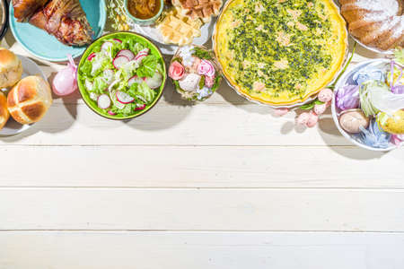 Festive dinner, Easter brunch. Traditional Easter dishes on family home table - baked meat, quiche,...