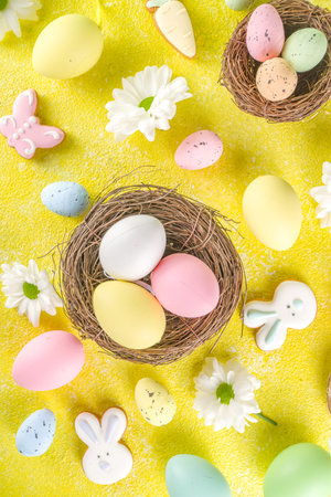 Easter poster background with Easter eggs in nests on yellow background. Greetings card, presents...