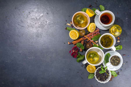 Various tea ball bombs. Assortment of different tea balls with dried tea, cups, lemon and mint, top view copy space. Trendy modern tea varietyの写真素材