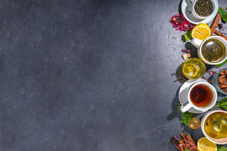 Various tea ball bombs. Assortment of different tea balls with dried tea, cups, lemon and mint, top view copy space. Trendy modern tea varietyの写真素材