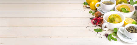 Various tea ball bombs. Assortment of different tea balls with dried tea, cups, lemon and mint, top view copy space. Trendy modern tea varietyの写真素材