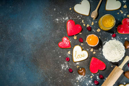 Valentine day sweet cooking background. Baking ingredients and utensils - flour, rolling pin, heart...