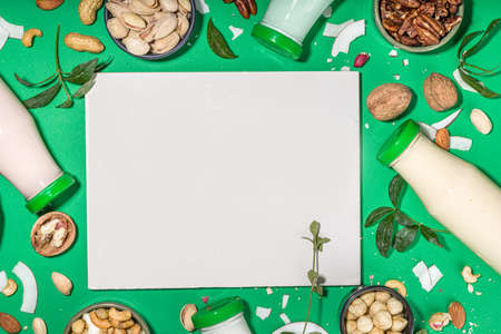 keto, paleo and vegan diet concept. Set of nut milks, bottles with various non-dairy nut milk - pistachio, walnut, hazelnut, peanut, almond, cashew, pecan, brazil nut, seeds, coconutの写真素材