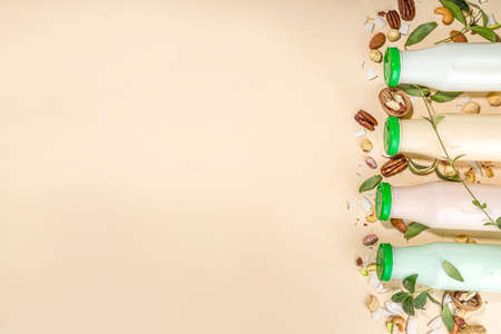 keto, paleo and vegan diet concept. Set of nut milks, bottles with various non-dairy nut milk - pistachio, walnut, hazelnut, peanut, almond, cashew, pecan, brazil nut, seeds, coconutの写真素材