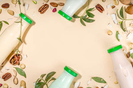 keto, paleo and vegan diet concept. Set of nut milks, bottles with various non-dairy nut milk - pistachio, walnut, hazelnut, peanut, almond, cashew, pecan, brazil nut, seeds, coconutの写真素材