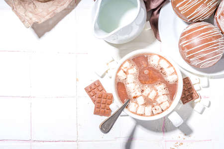 Homemade hot chocolate bomb with marshmallow and chocolates and nuts, Cooking making cocoa with chocolate ball, dropping coca bomb in milkの写真素材