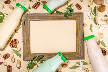 keto, paleo and vegan diet concept. Set of nut milks, bottles with various non-dairy nut milk - pistachio, walnut, hazelnut, peanut, almond, cashew, pecan, brazil nut, seeds, coconutの写真素材