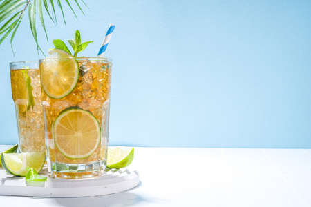 Cuba Libre, long island iced tea cocktail with strong alcohol drink, cola, lime and ice in two...