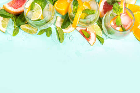 Summer healthy cocktails, mocktails. Set of various citrus lemonades mojito, with lime, lemon, orange, grapefruit, diet detox beverages on light blue turquoise background copy spaceの写真素材