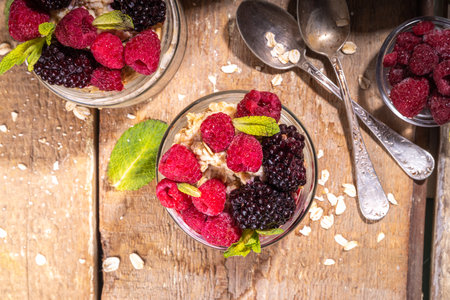 Healthy Homemade Overnight Oats Oatmeal with berry. Portioned Oatmeal porridge with fresh raspberry ans blackberry in a glass jar. Healthy summer breakfastの写真素材