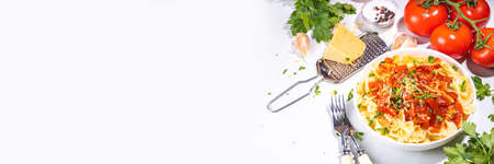 Mediterranean Italian pasta lunch. Classic pasta with marinara sauce, farfalle pasta with tomato sauce, cheese, fresh herbsの写真素材