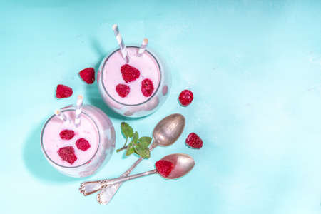 Raspberry smoothie, milkshake or yogurt. Fresh raw organic berry drink in glasses