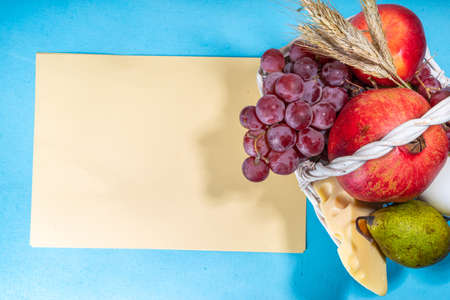 Happy Shavuot greeting card with food Symbols of jewish Shavuot holiday - pomegranate, grapes,...