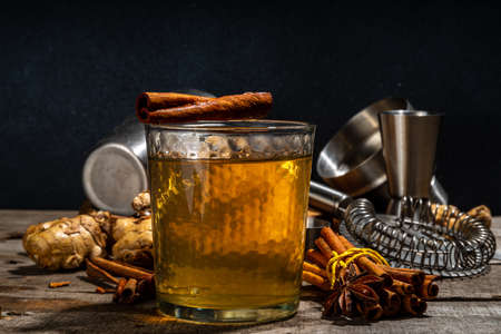 Whiskey Old Fashioned Cinnamon Stick. Strong alcohol cocktail with cinnamon and ginger, autumn...